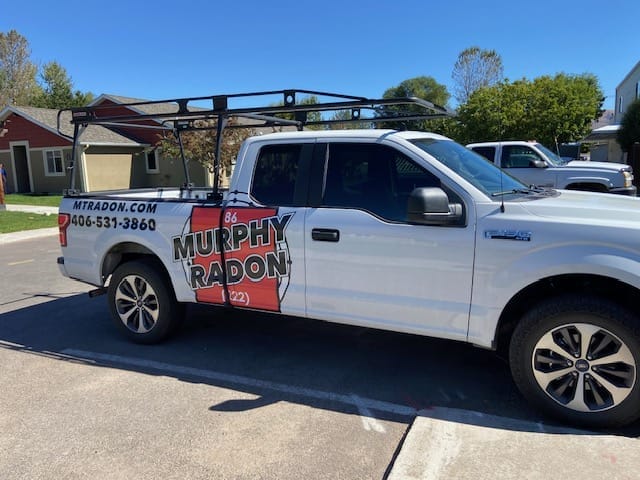 An original photo of one of Murphy Radon's trucks, featuring a white exterior with the Murphy Radon logo and phone number.
